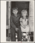 Children of migrants sitting in doorway of trailer, Edinburg, Texas