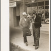 Men talking on sidewalks of Sinton, Texas