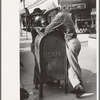 Men leaning on mailbox, Crystal City, Texas