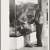 Residents of Crystal City, Texas, talking in front of grocery store