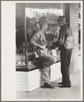 Residents of Crystal City, Texas, talking in front of grocery store