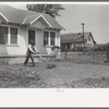 Negro mowing lawn, San Augustine, Texas