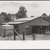 Barn and water tank of FSA (Farm Security Administration) client, Sabine Farms, Marshall, Texas