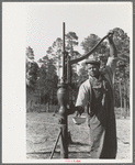 FSA (Farm Security Administration) client pumping water from his sanitary well, Sabine Farms, Marshall, Texas