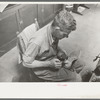 Applying glue to heel before putting on another piece of leather. Bootmaking shop, Alpine, Texas