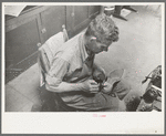 Applying glue to heel before putting on another piece of leather. Bootmaking shop, Alpine, Texas