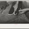 Cementing beading to upper, cowboy boot shop. Alpine, Texas