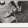 Attaching piece of leather in arch of sole by means of wooden pegs. Cowboy bootmaking shop, Alpine, Texas