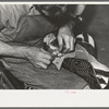 Roughening leather of lower part of boot before attaching upper with glue. Bootmaking shop, Alpine, Texas