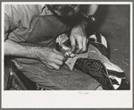 Roughening leather of lower part of boot before attaching upper with glue. Bootmaking shop, Alpine, Texas