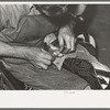 Roughening leather of lower part of boot before attaching upper with glue. Bootmaking shop, Alpine, Texas