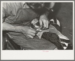 Roughening leather of lower part of boot before attaching upper with glue. Bootmaking shop, Alpine, Texas