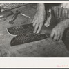Fitting upper to lower part of boot. Bootmaking shop, Alpine, Texas