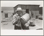 Pouring gasoline into tractor, large farm near Ralls, Texas. Man is day laborer