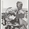 Son of day laborer on farm near Ralls, Texas. He is drinking from the jug which is carried on his father's tractor