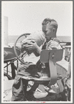 Son of day laborer on farm near Ralls, Texas. He is drinking from the jug which is carried on his father's tractor