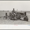 Tractor with planter and go-devil attached, large farm near Ralls, Texas