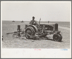 Tractor with planter and go-devil attached, large farm near Ralls, Texas