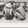 Day laborers at work on tractor, large farm near Ralls, Texas