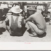 Day laborers at work on tractor, large farm near Ralls, Texas