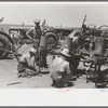Day laborers working on tractors, large farm near Ralls, Texas