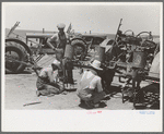 Day laborers working on tractors, large farm near Ralls, Texas