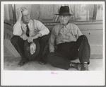 Farmers sitting against wall and squatting on sidewalk, Spur, Texas