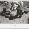 Camp cook working over an open fire, cattle ranch near Spur, Texas. The old attitude of the inferiority of the cook on the range is still prevalent. This cook said "the boys treat me awfully good."