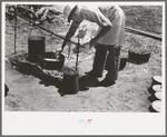 Camp cook working over an open fire, cattle ranch near Spur, Texas. The old attitude of the inferiority of the cook on the range is still prevalent. This cook said "the boys treat me awfully good."