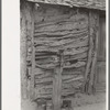 Detail of Mexican house made of sticks and mud. Corn grinder is on post in front. Crystal City, Texas