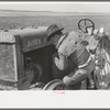 Starting a tractor by starting the flywheel, El Indio, Texas