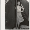 Daughter of migrant strawberry picker in doorway of tent home near Hammond, Louisiana