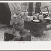 Child of migrant strawberry picker in front of tent home near Hammond, Louisiana