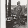 Migrant mother in front of outdoor stove near Hammond, Louisiana strawberry center
