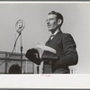 Itinerant preacher broadcasting to his audience by means of public address system on streets of Marshall, Texas