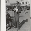 Itinerant preacher broadcasting to his audience by means of public address system on streets of Marshall, Texas