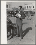 Itinerant preacher broadcasting to his audience by means of public address system on streets of Marshall, Texas