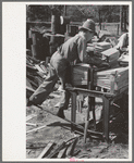 Young boy packing shingles at small mill near Jefferson, Texas