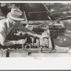 Sawing shingles by means of horizontal circular saw at small mill near Jefferson, Texas
