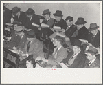 Group of buyers at strawberry auction, Hammond, Louisiana. Third man from right in front row is bidding