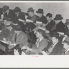 Group of buyers at strawberry auction, Hammond, Louisiana. Third man from right in front row is bidding