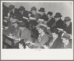 Group of buyers at strawberry auction, Hammond, Louisiana. Third man from right in front row is bidding