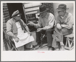 Two farmers talking to popcorn man, San Augustine, Texas