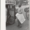 Negro farmer with supplies and freshly pressed suit, Saturday afternoon, San Augustine, Texas