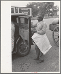 Negro farmer with supplies and freshly pressed suit, Saturday afternoon, San Augustine, Texas