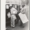 Negro farmer with supplies and freshly pressed suit, Saturday afternoon, San Augustine, Texas
