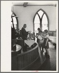 Preacher reading the lesson and instructions before baptism, San Augustine, Texas