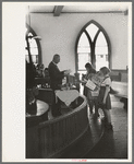 Preacher reading the lesson and instructions before baptism, San Augustine, Texas