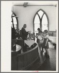 Preacher reading the lesson and instructions before baptism, San Augustine, Texas