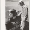 Farmer changing license plates, San Augustine, Texas